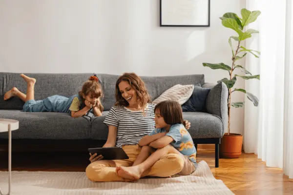 Mom and children in living room sitting on floor