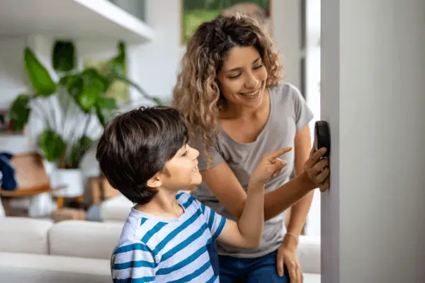 Mom and son working on thermostat